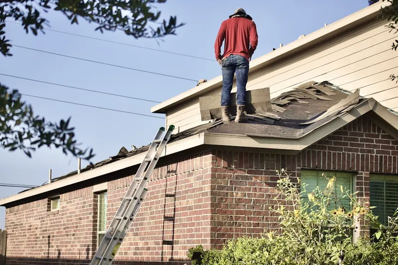 Professional roofer working on a residential roof in Pasco
